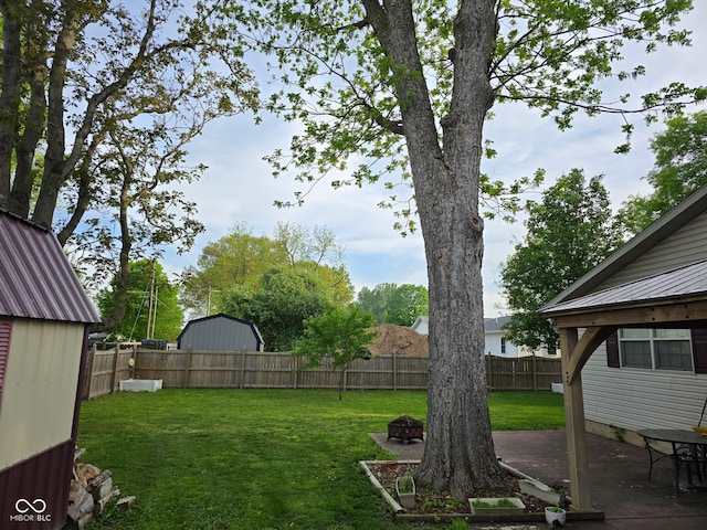 view of yard featuring a fire pit and a patio