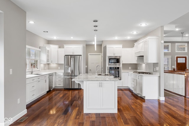 888 Westcreek Dr, Columbus, IN 47201 - kitchen with stainless steel appliances, dark wood finished floors, white cabinetry, a center island with sink, and recessed lighting