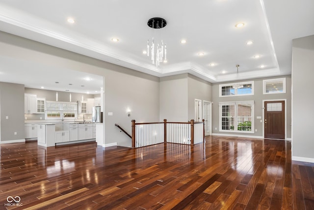 888 Westcreek Dr, Columbus, IN 47201 - unfurnished living room featuring wood finished floors, a raised ceiling, and recessed lighting