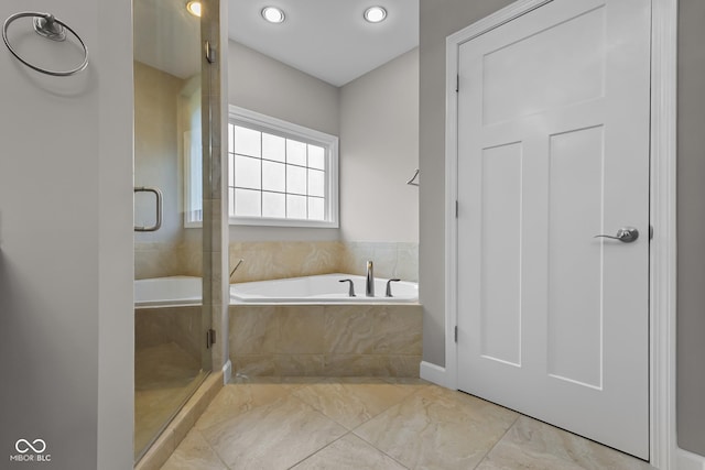888 Westcreek Dr, Columbus, IN 47201 - bathroom with a bath, a stall shower, marble look tile flooring, and recessed lighting
