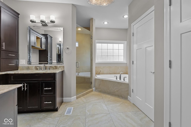 888 Westcreek Dr, Columbus, IN 47201 - bathroom featuring vanity, a stall shower, a garden tub, marble finish flooring, and recessed lighting