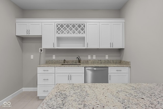 888 Westcreek Dr, Columbus, IN 47201 - kitchen with stainless steel dishwasher, white cabinetry, light stone counters, open shelves, and light wood finished floors