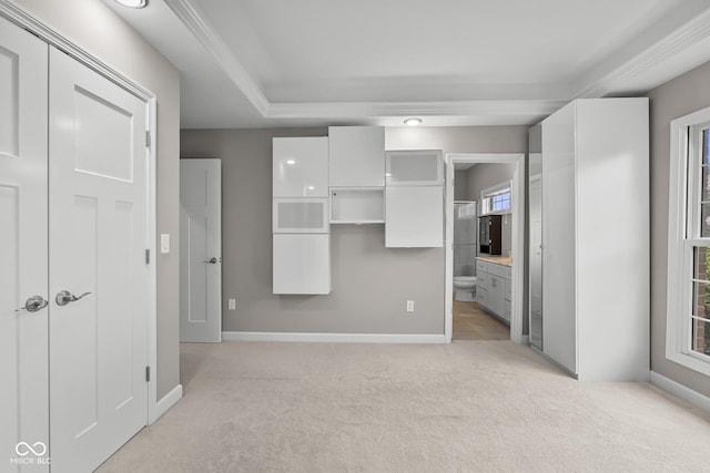 888 Westcreek Dr, Columbus, IN 47201 - unfurnished bedroom featuring light carpet, ensuite bathroom, a closet, and a walk in closet