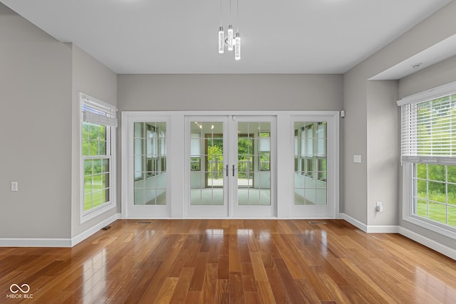 888 Westcreek Dr, Columbus, IN 47201 - interior space featuring wood finished floors, french doors, and a chandelier