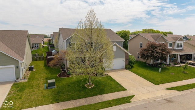 695 Bobtail Dr, Greenfield, IN 46140 - view of front of property with a residential view, concrete driveway, a garage, a front yard, and central AC unit