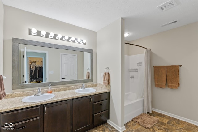695 Bobtail Dr, Greenfield, IN 46140 - bathroom featuring double vanity, baseboards, shower / bath combo with shower curtain, and a spacious closet