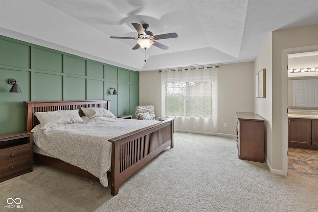 695 Bobtail Dr, Greenfield, IN 46140 - bedroom with light carpet, a raised ceiling, ensuite bathroom, ceiling fan, and baseboards
