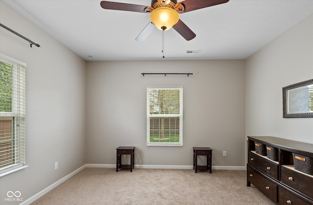 695 Bobtail Dr, Greenfield, IN 46140 - spare room with a ceiling fan, light colored carpet, and baseboards