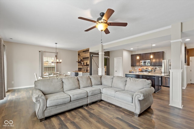 695 Bobtail Dr, Greenfield, IN 46140 - living room with decorative columns, a ceiling fan, dark wood finished floors, baseboards, and a chandelier
