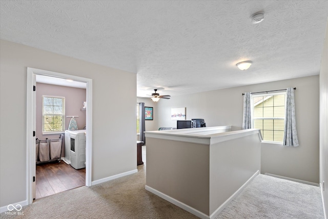 695 Bobtail Dr, Greenfield, IN 46140 - corridor featuring carpet, washer / clothes dryer, healthy amount of natural light, baseboards, and a textured ceiling
