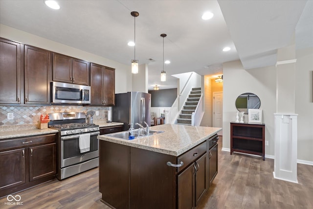 695 Bobtail Dr, Greenfield, IN 46140 - kitchen with appliances with stainless steel finishes, a sink, dark wood-type flooring, dark brown cabinetry, and decorative backsplash