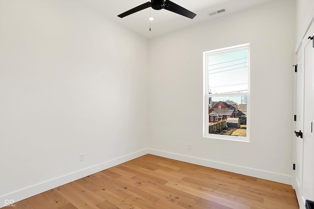 unfurnished room featuring baseboards, ceiling fan, and light wood finished floors