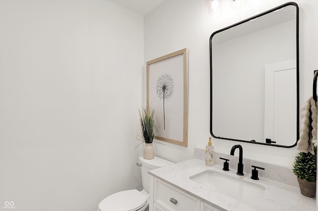 bathroom with toilet and vanity