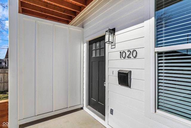 view of exterior entry featuring board and batten siding