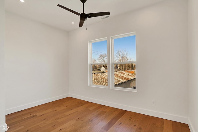 spare room with baseboards, a ceiling fan, hardwood / wood-style flooring, and recessed lighting