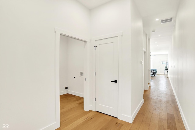 hall with light wood-style floors, baseboards, and recessed lighting