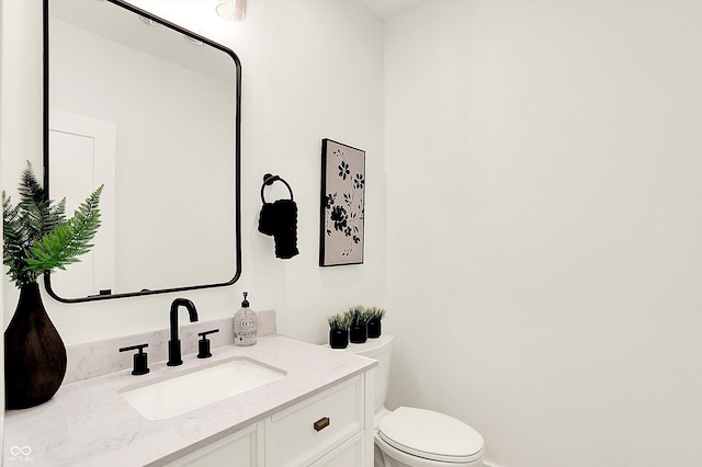bathroom with toilet and vanity