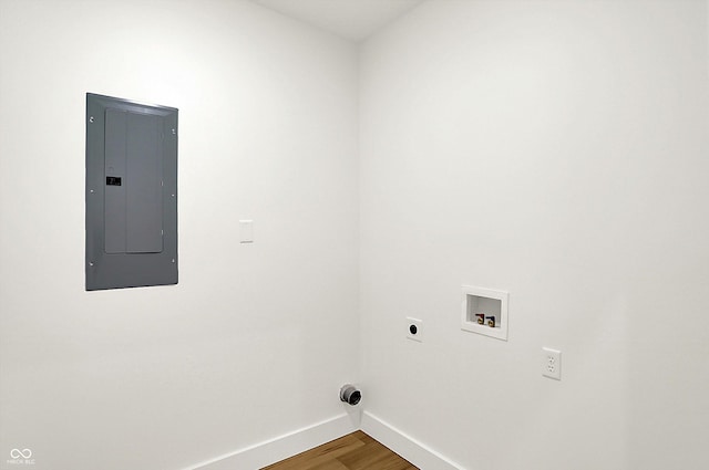 washroom featuring electric panel, baseboards, hookup for a washing machine, wood finished floors, and hookup for an electric dryer