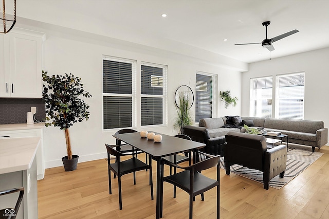 dining area with light wood finished floors, recessed lighting, and a ceiling fan