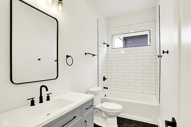 bathroom featuring toilet, vanity, bathing tub / shower combination, and tile patterned flooring