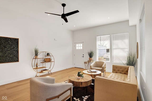living room with a ceiling fan, wood finished floors, recessed lighting, and baseboards