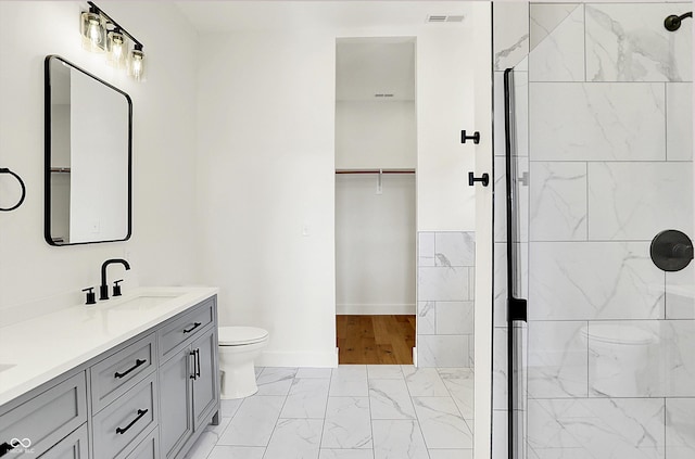 full bath with toilet, marble finish flooring, a shower, and baseboards