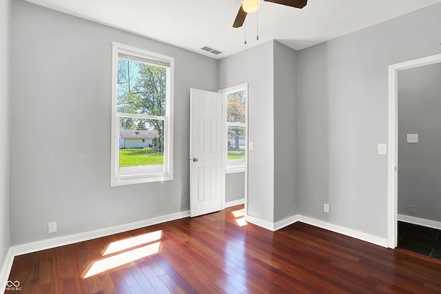 unfurnished room featuring hardwood / wood-style flooring, ceiling fan, and baseboards