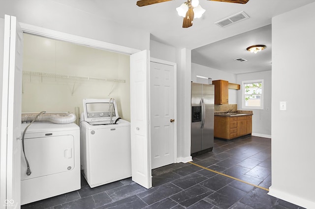 clothes washing area with independent washer and dryer, ceiling fan, and baseboards