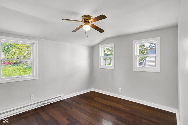 spare room with baseboard heating, vaulted ceiling, ceiling fan, dark wood-style flooring, and baseboards