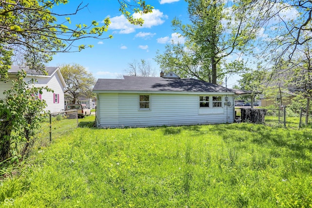 back of property featuring fence and a chimney