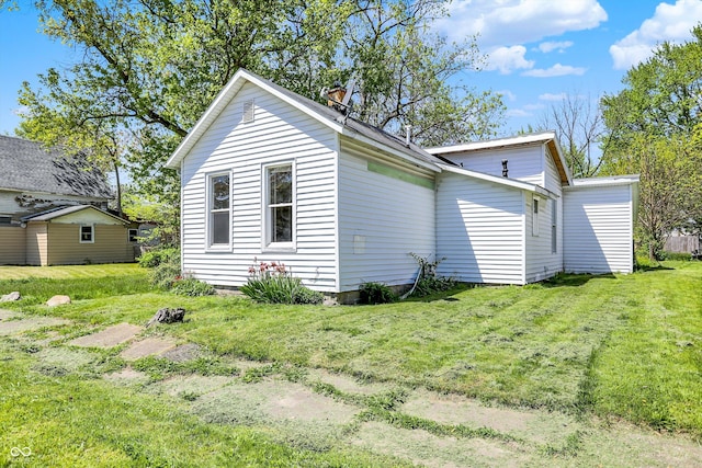 view of side of home featuring a lawn