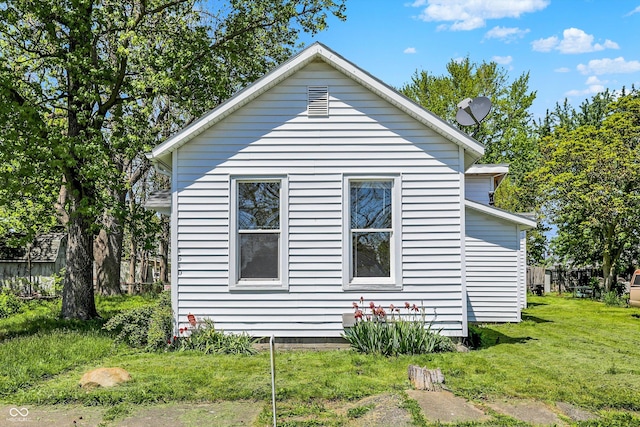 view of property exterior with a lawn