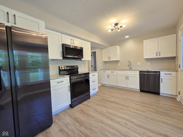 6369 Kelsey Dr, Indianapolis, IN 46268 - kitchen with appliances with stainless steel finishes, light wood finished floors, white cabinets, a sink, and light stone countertops