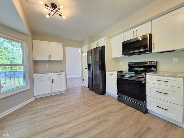 6369 Kelsey Dr, Indianapolis, IN 46268 - kitchen with stainless steel appliances, light wood-style flooring, white cabinets, baseboards, and light stone counters