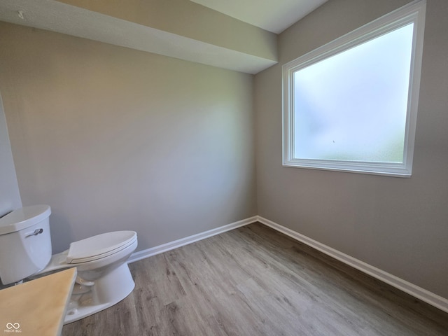 6369 Kelsey Dr, Indianapolis, IN 46268 - bathroom featuring wood finished floors, toilet, and baseboards
