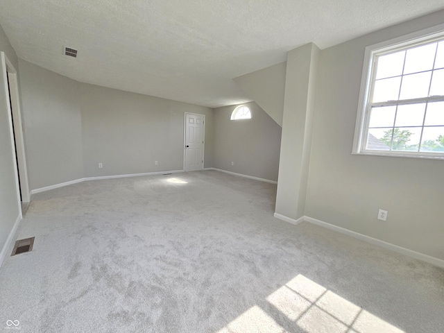 6369 Kelsey Dr, Indianapolis, IN 46268 - spare room featuring carpet, baseboards, and a textured ceiling