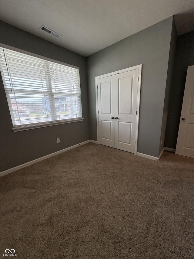 1380 Fairmount Dr, Greenfield, IN 46140 - unfurnished bedroom featuring carpet flooring, baseboards, and a closet