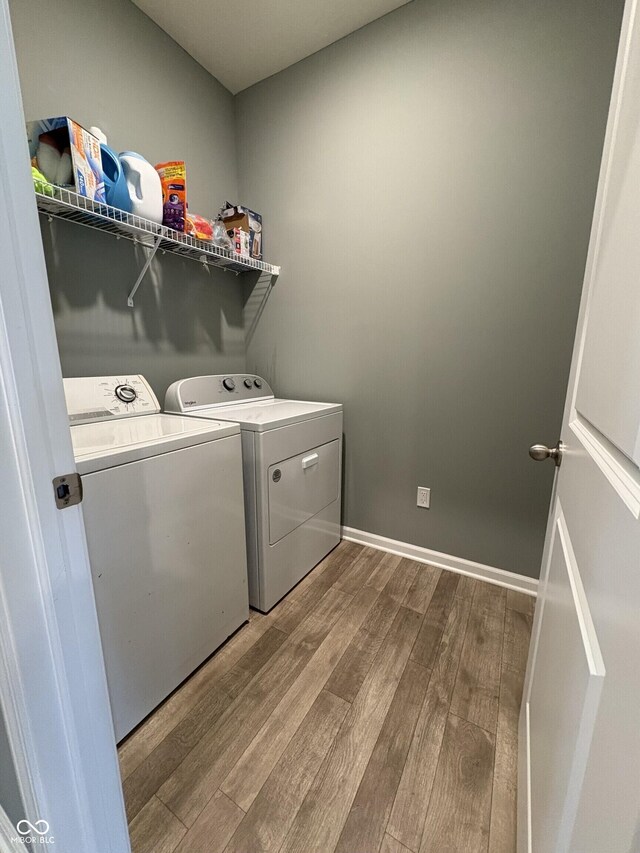 1380 Fairmount Dr, Greenfield, IN 46140 - laundry room featuring wood finished floors, washing machine and dryer, and baseboards
