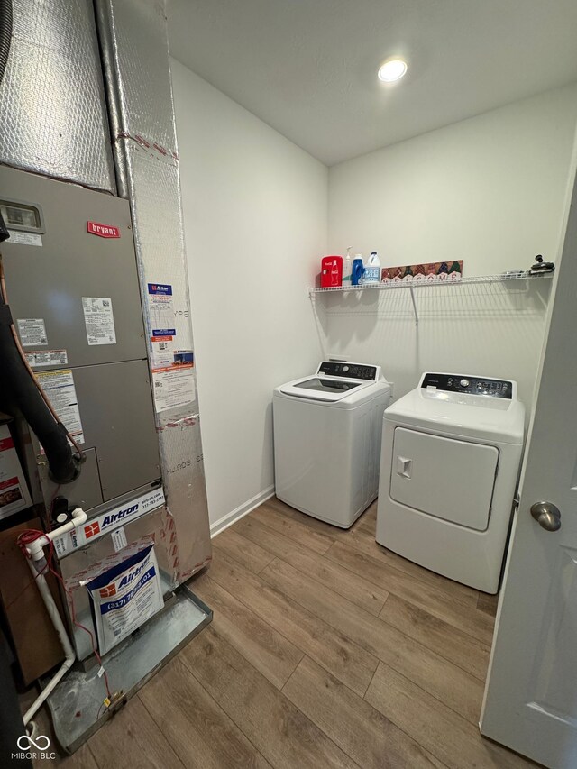 142 Winding Brook Way, Pendleton, IN 46064 - laundry room with independent washer and dryer, light wood-style flooring, heating unit, and baseboards