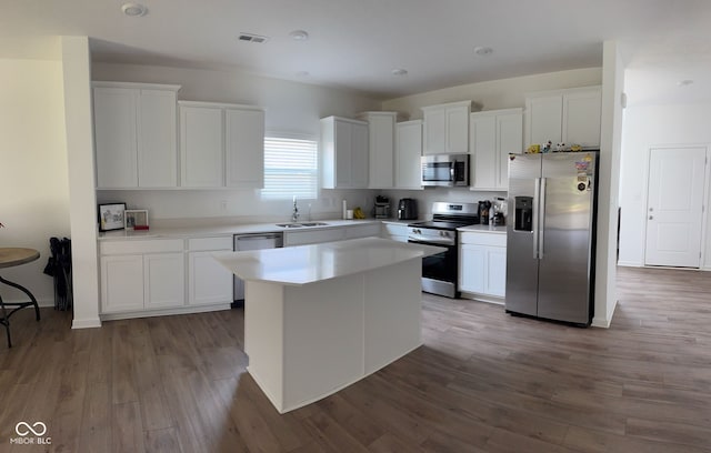 142 Winding Brook Way, Pendleton, IN 46064 - kitchen featuring appliances with stainless steel finishes, a sink, white cabinetry, wood finished floors, and recessed lighting