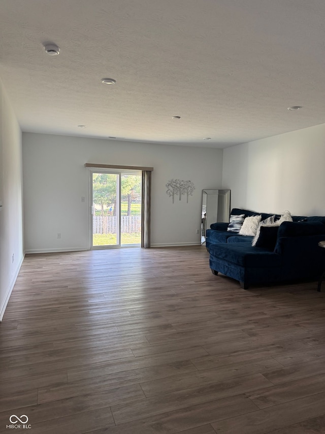 142 Winding Brook Way, Pendleton, IN 46064 - living area featuring dark wood-style floors, baseboards, a textured ceiling, and recessed lighting