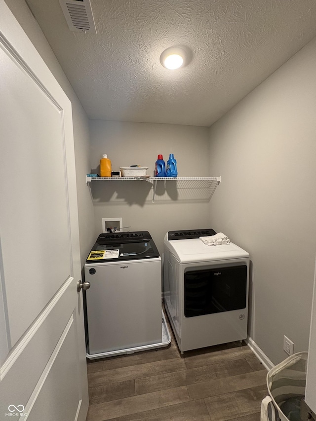 10931 N Longbranch St, Monrovia, IN 46157 - washroom featuring washer and clothes dryer, dark wood-style flooring, and a textured ceiling