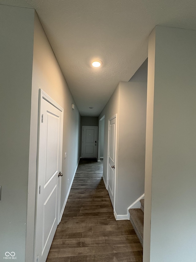 10931 N Longbranch St, Monrovia, IN 46157 - hallway with dark wood finished floors, baseboards, stairs, and a textured ceiling
