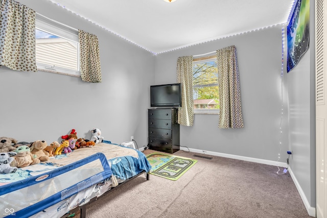 bedroom with baseboards, carpet floors, and vaulted ceiling