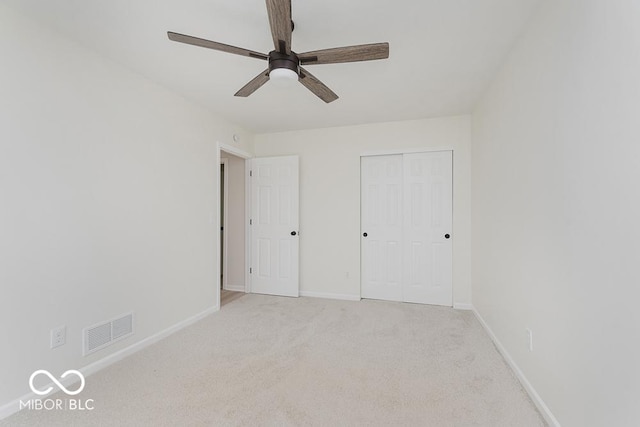 unfurnished bedroom featuring baseboards, carpet flooring, a closet, and ceiling fan