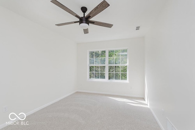 unfurnished room with baseboards, carpet flooring, and a ceiling fan