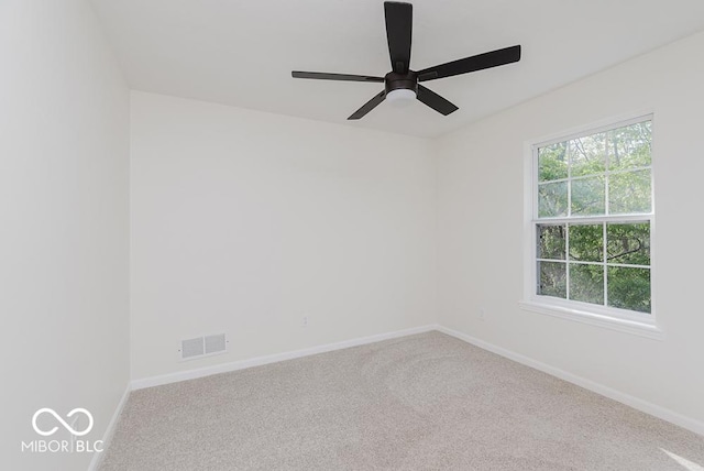 empty room with carpet, baseboards, and ceiling fan
