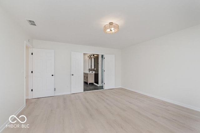 unfurnished bedroom featuring light wood-style flooring and baseboards