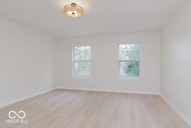 unfurnished room featuring light wood finished floors and baseboards