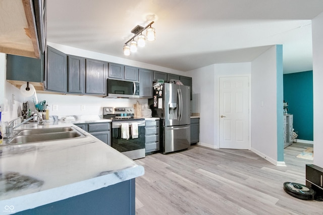 6190 E Ayrshire Cir, Camby, IN 46113 - kitchen with appliances with stainless steel finishes, a sink, light countertops, and light wood-style floors